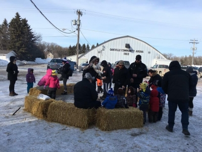 People roast marshmallows around the bonfire at Winterfest