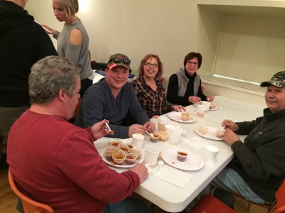 Everyone's having a great time warming up with chili and brews after a fun afternoon in the snow