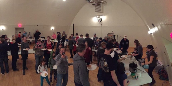 People lining up to try out all of the competitors' chilies