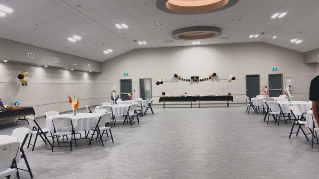 An event set up in the banquet hall including round table seating and a buffet table