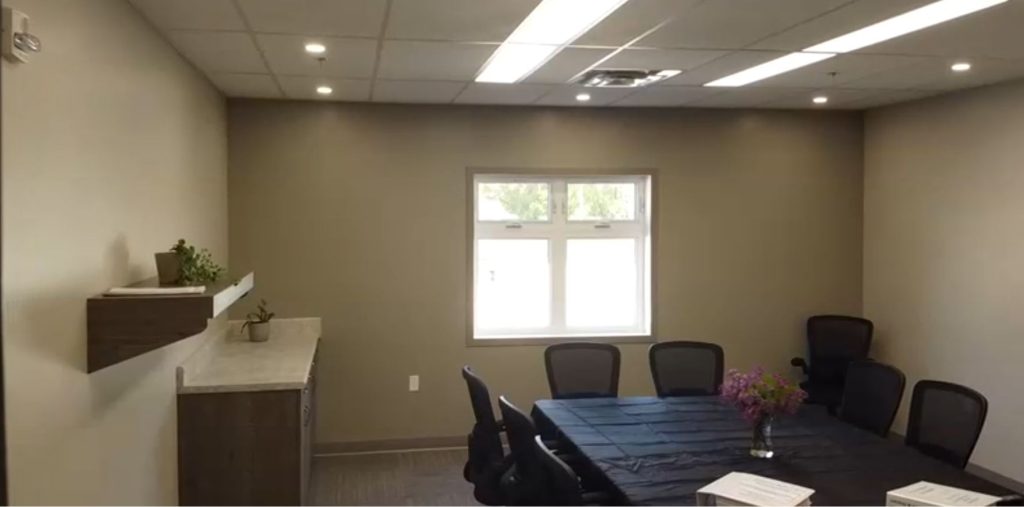 The community centre meeting room, including a conference table with chairs and some counterspace